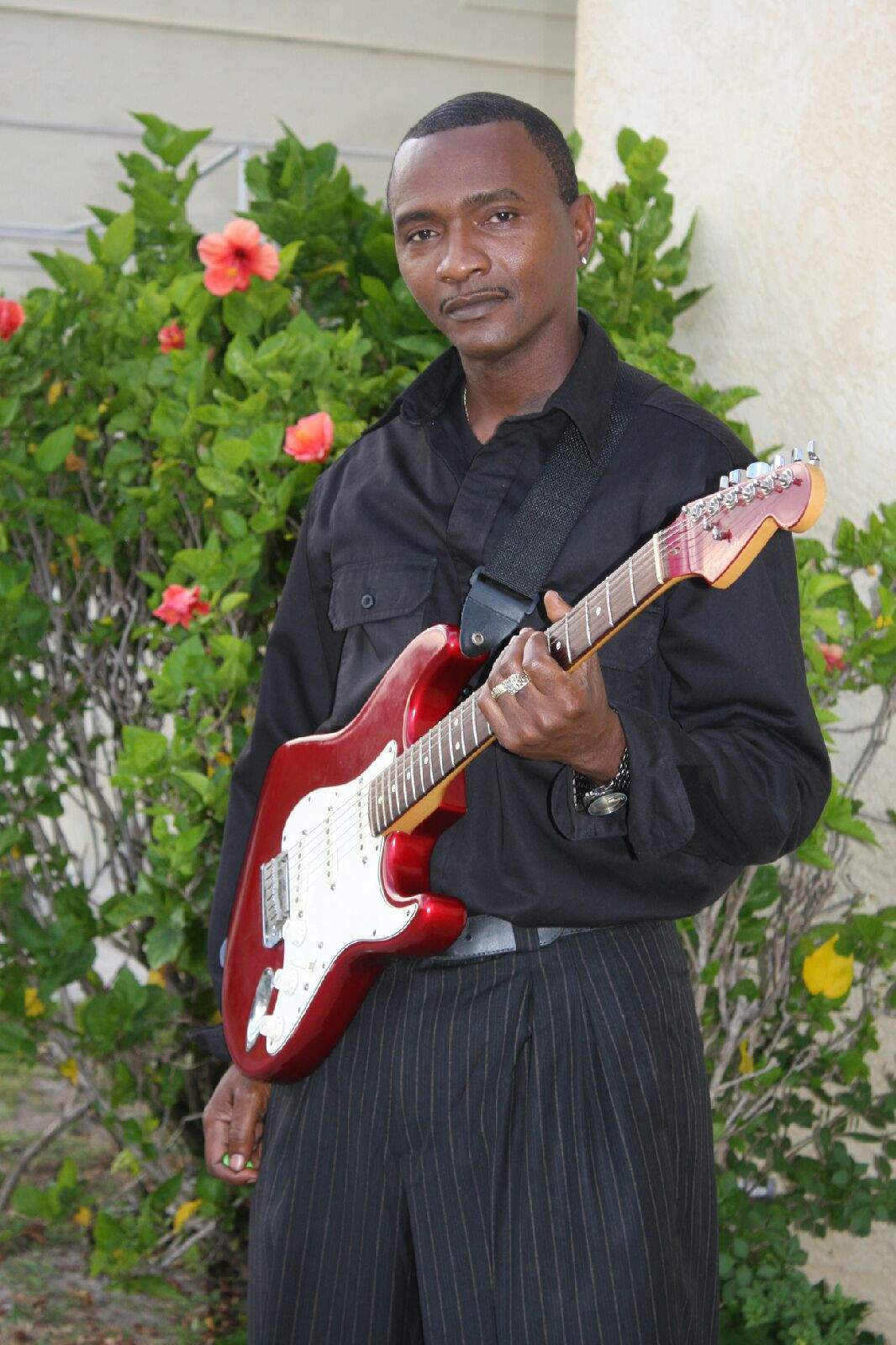 Man holding red bass guitar